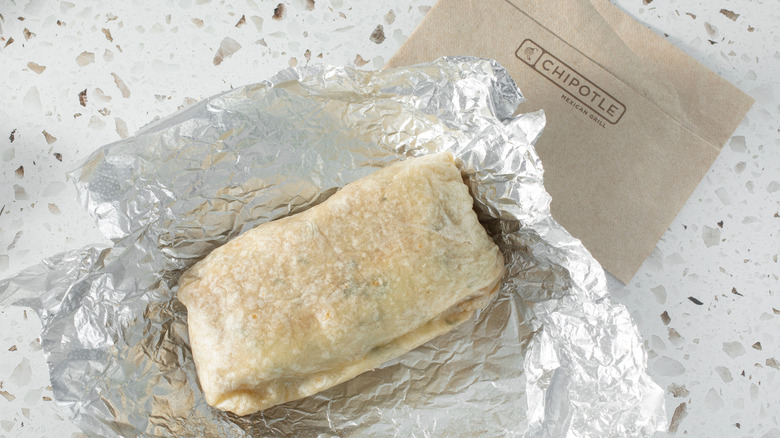 chipotle burrito in tin foil on counter