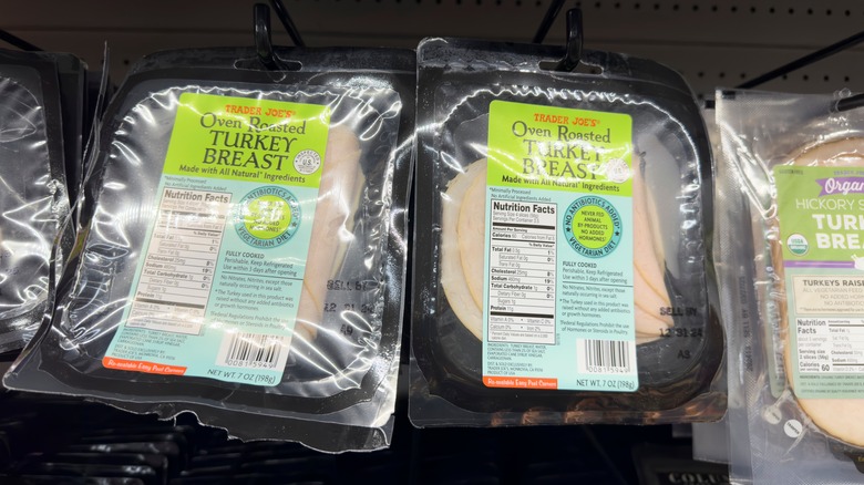 Black packages of Trader Joe's oven roasted turkey breast