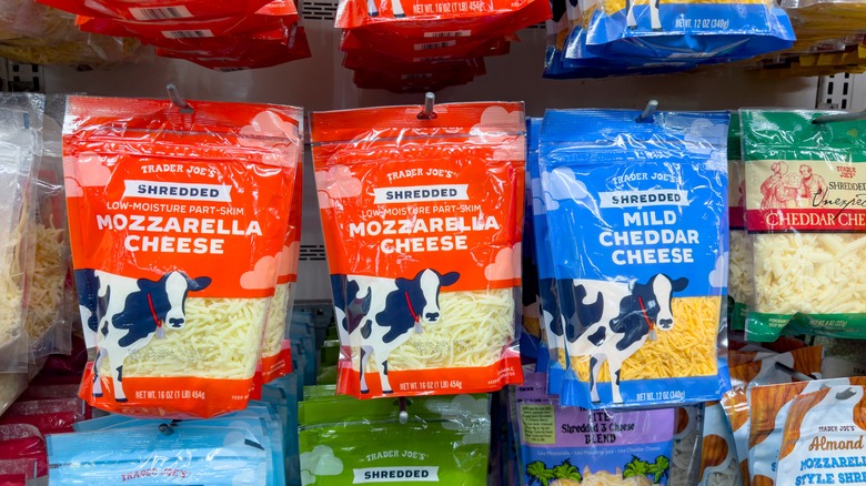 Colorful bags of shredded cheeses on display at Trader Joe's