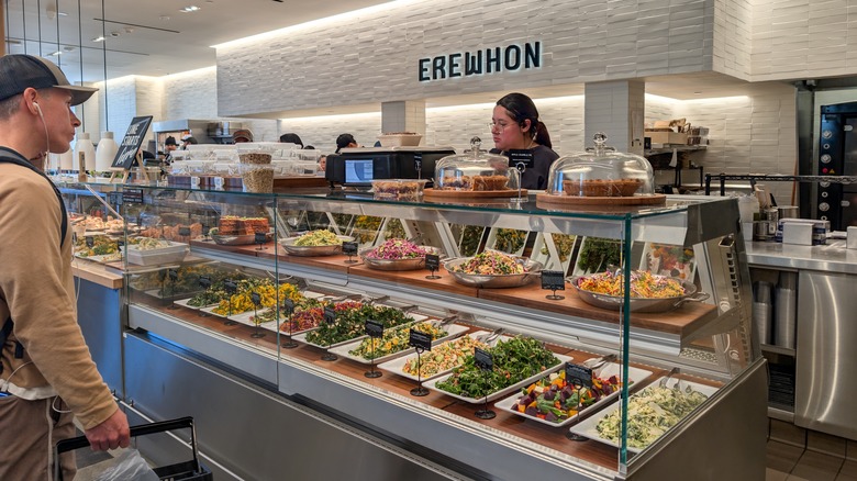 Customer at the prepared foods counter in Erewhon grocery store