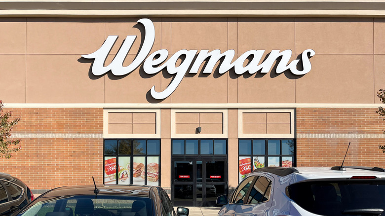 cars parked in front of a Wegmans store