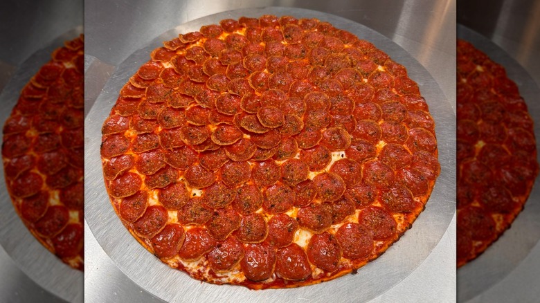 donatos pizza on a round steel disk