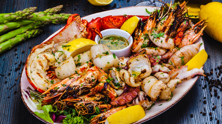 A seafood platter with lobster tails, shrimp, scallops and fish fillets.