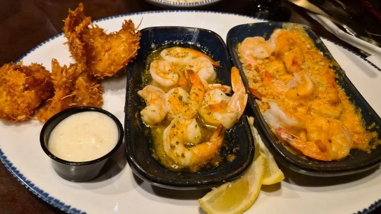 A plate of three shrimp dishes: Coconut Shrimp, Garlic Shrimp Scampi and Garlic-Bread-Crusted Shrimp.