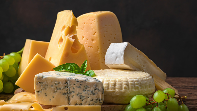 A variety of cheeses garnished with green grapes