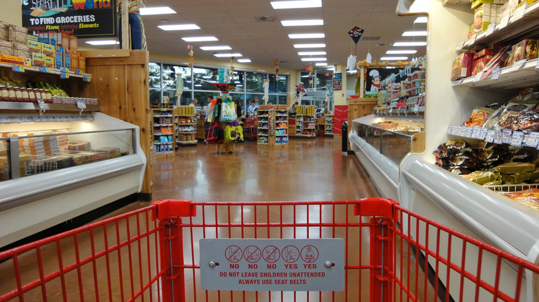 The view from inside of a red shopping cart within a Trader Joe's location.
