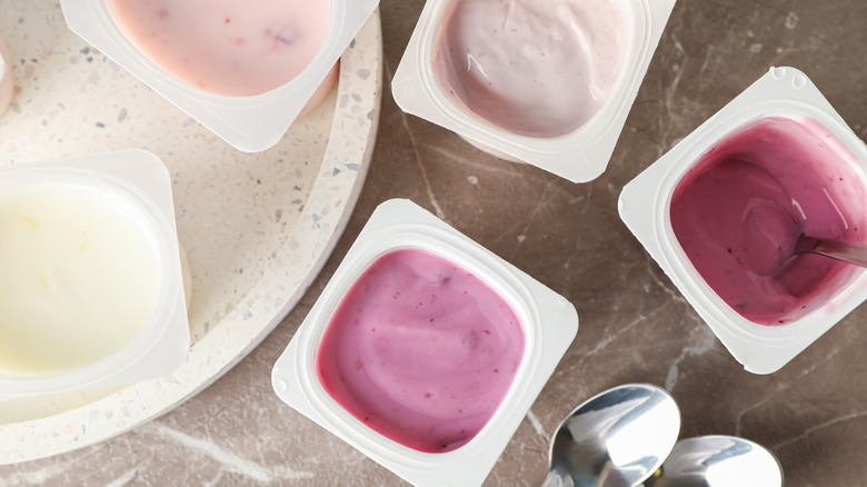 Top view of assorted individual plastic cups of yogurt