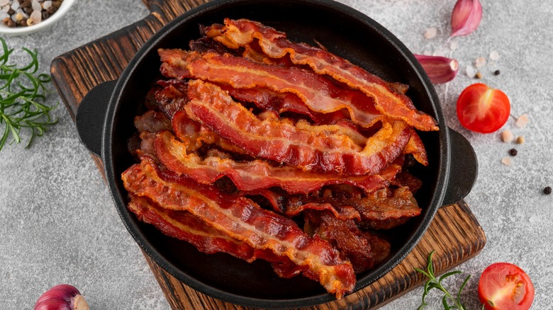 Crispy bacon strips in cast iron pan