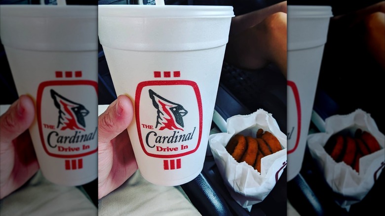 Hand holding Cardinal Drive In cup