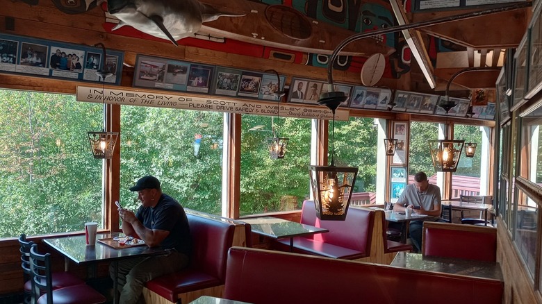 Inside Arctic Roadrunner Dining Room with Rustic Memorabilia Man sitting at table