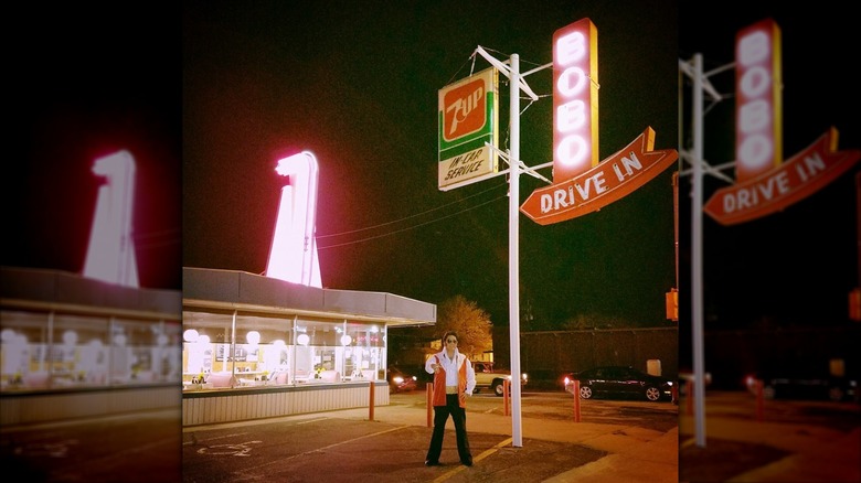 Bobo's Drive In exterior shot at night with neon sign and Elvis impersonator