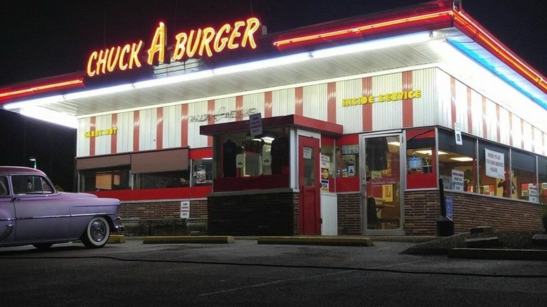 Chuck A Burger brightly lit exterior at night with vintage car in parking lot