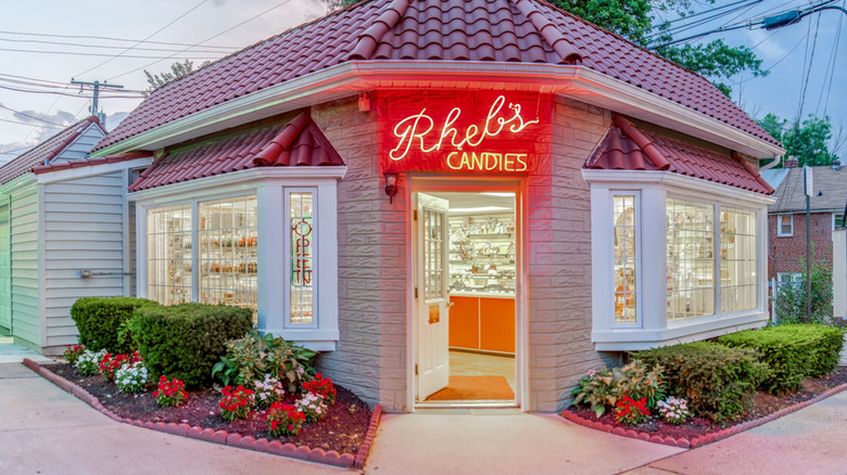 Exterior of Rheb's Candies as dusk with neon sign