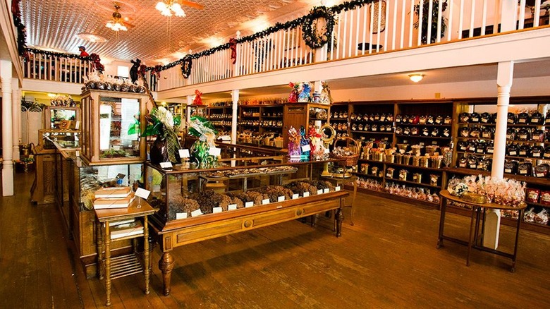 The Sweet Palace interior with white walls, Christmas decor, and candy