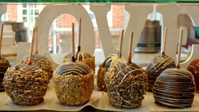 Candied apples lined up behind glass display