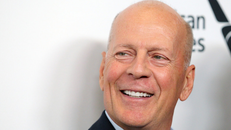 A close-up of Bruce Willis smiling at an event