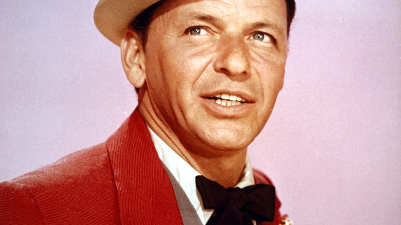 Frank Sinatra in red jacket and white hat