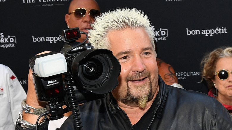 Guy Fieri holding camera