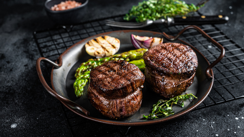 filet mignon steaks on a black plate