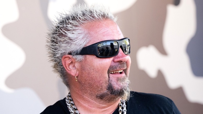 Guy Fieri wearing sunglasses and smiling