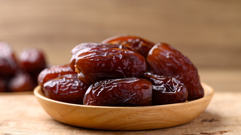 Medjool dates in wooden bowl