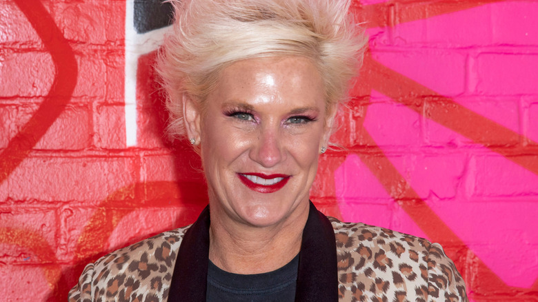 Anne Burrell smiles in animal print at an event