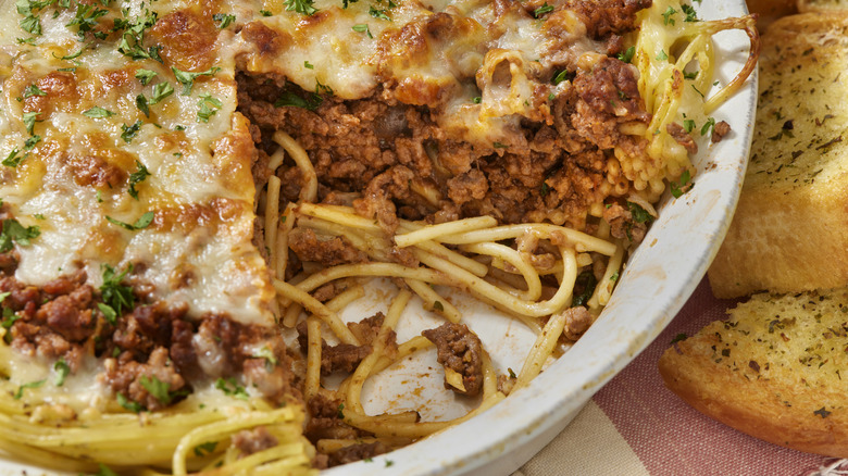 baked spaghetti in a white pie pan