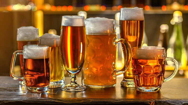 Assorted glasses of beer on bar counter