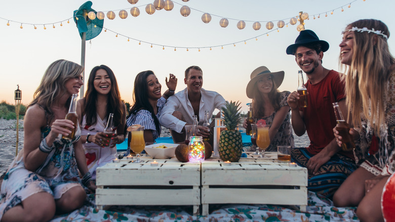 Friends at casual sunset beach party