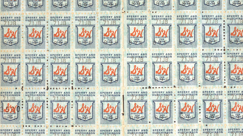 A collection of S&H Green Stamps all lined up next to each other in neat rows and columns.