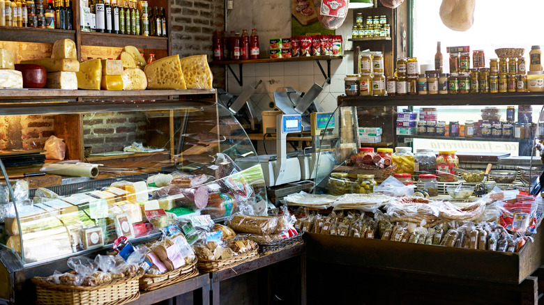Small gourmet grocery store with meats and cheeses in deli case