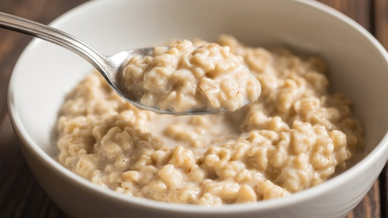 A bowl and spoon full of oatmeal