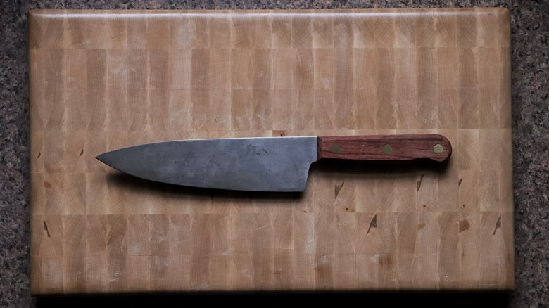 Old carbon steel knife on a cutting board