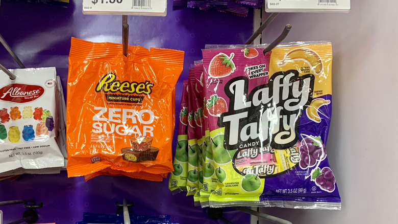 Several hanging bags of candy, including Reese's Zero Sugar and a variety bag of Laffy Taffy