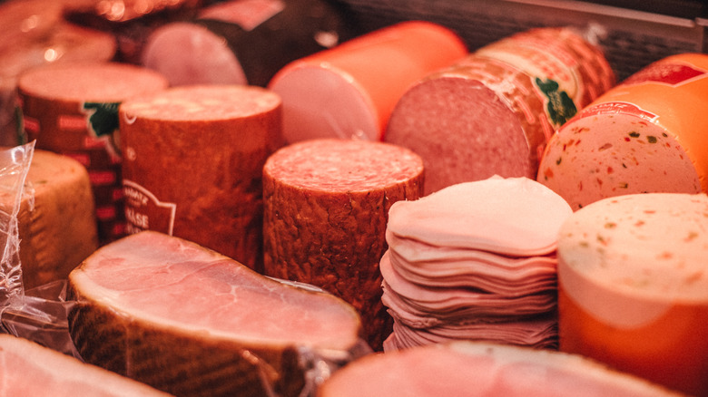 A variety of cold cuts in a deli case