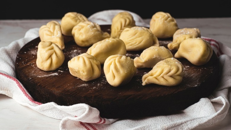 Culurgiones on a wooden board.