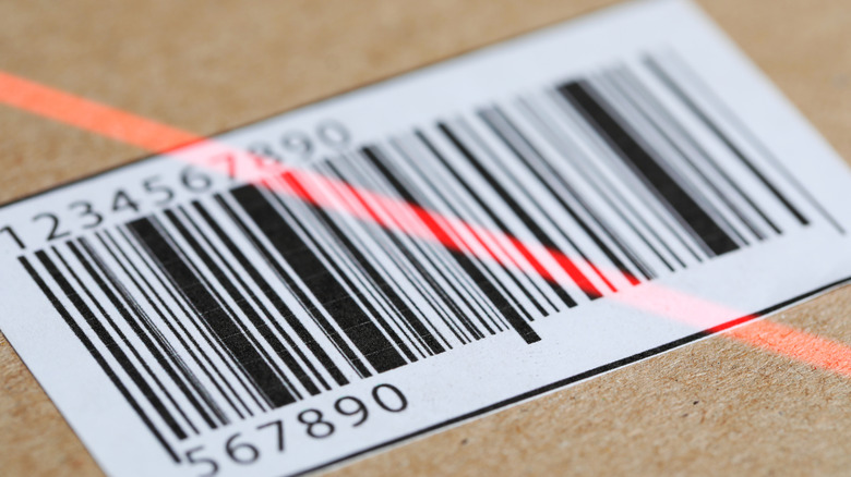 A closeup of a black and white barcode being scanned