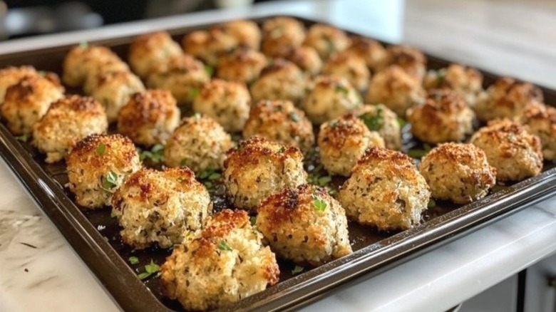 Golden brown stuffing balls arranged on a baking tray
