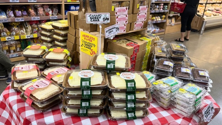 Bakery table display at Trader Joes with sheet cakes and various sweet treats