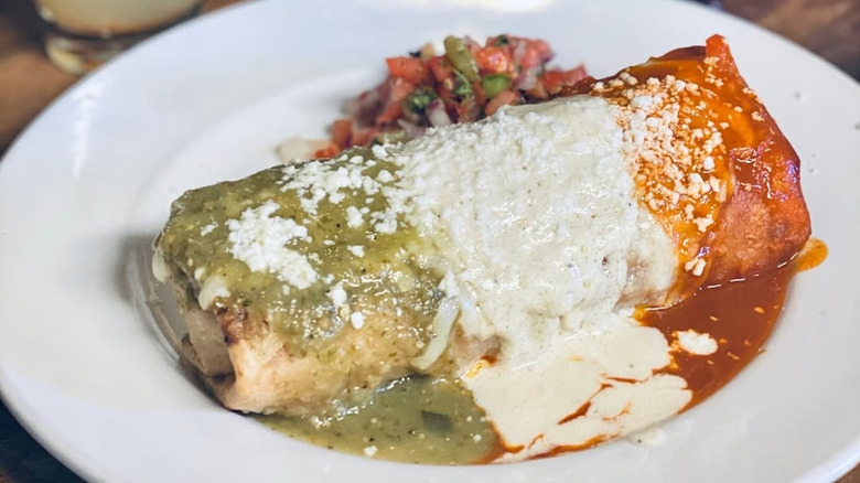Chimichanga with green, white, and red sauces from El Charro Café