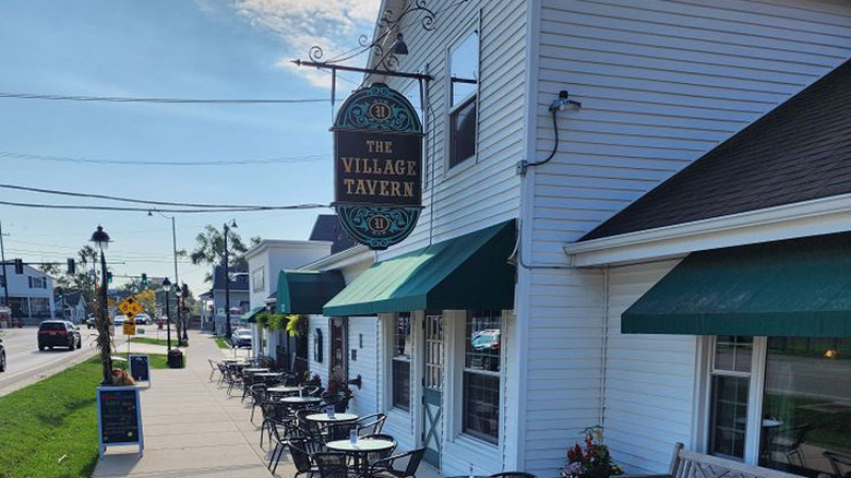 hanging outdoor sign at the Village Tavern in Illinois