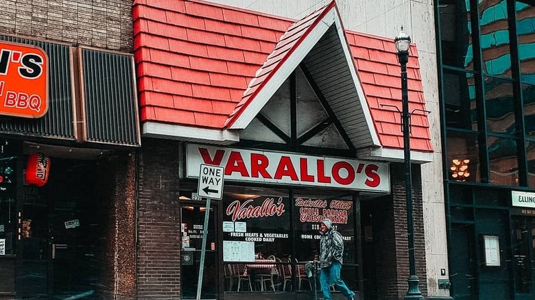 Varallo's restaurant front by other buildings