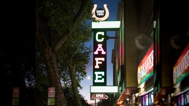 Horseshoe Cafe vertical sign lit up