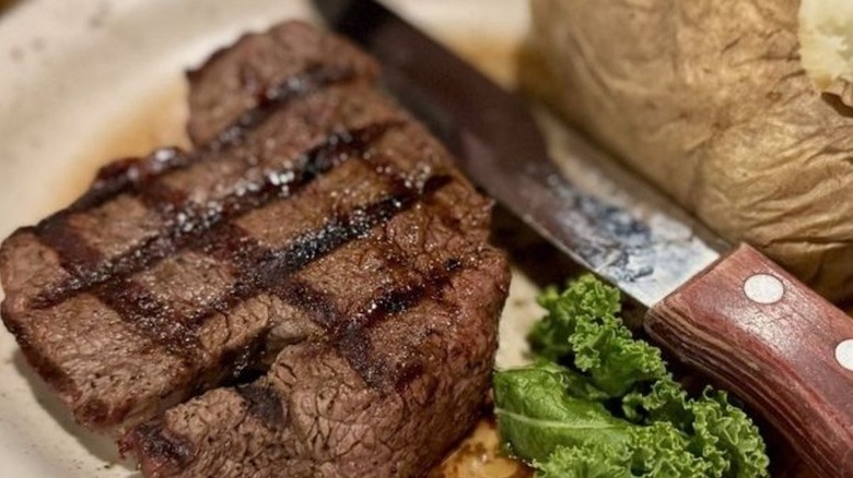 steak and potato on plate at Cattlemen's Steakhouse
