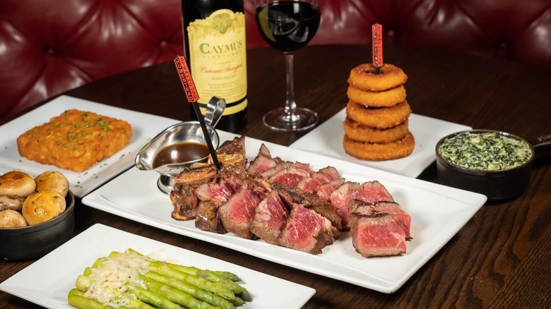 steak with sides and wine at The Old Homestead