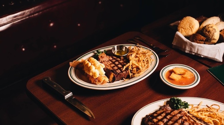 steaks on wood table at Pine Club