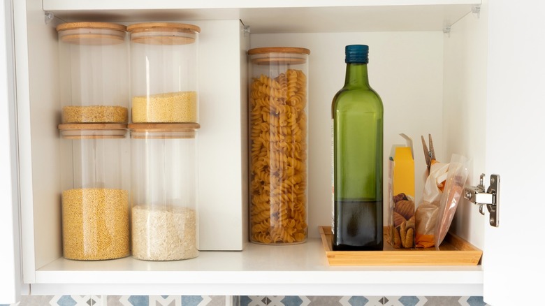 Pasta, rice, and olive oil in cupboard