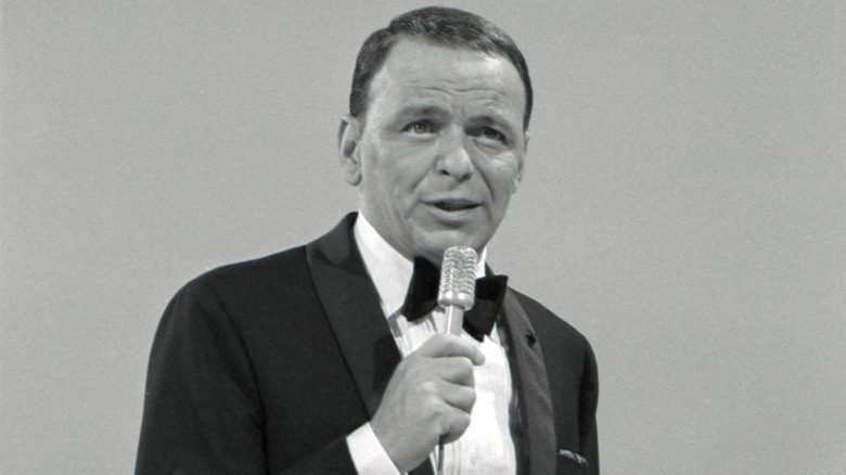 A picture of the legendary crooner Frank Sinatra performing on stage.