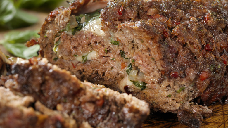 Juicy cooked meatloaf with cheese and herbs