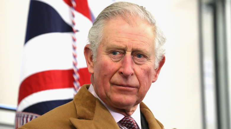 King Charles listening at an event.